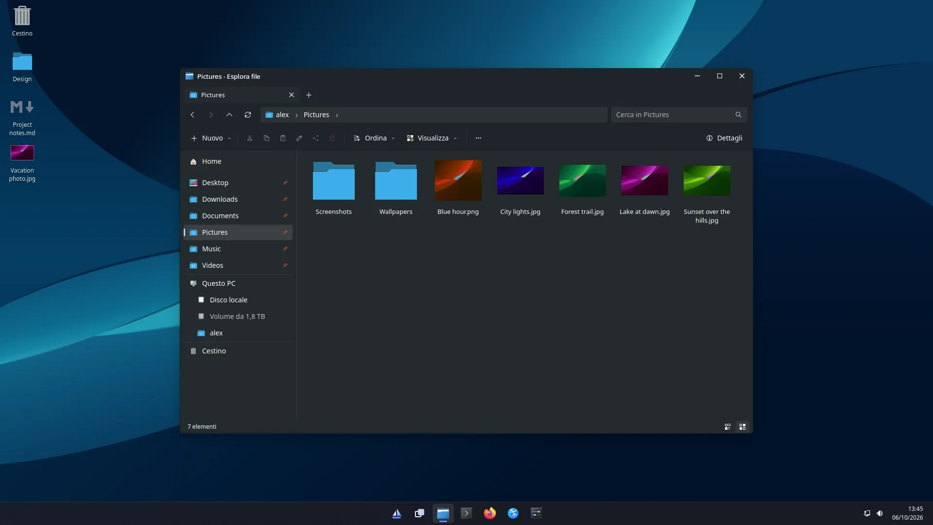 Files in dark mode, showing the Pictures folder, over the Vela desktop.